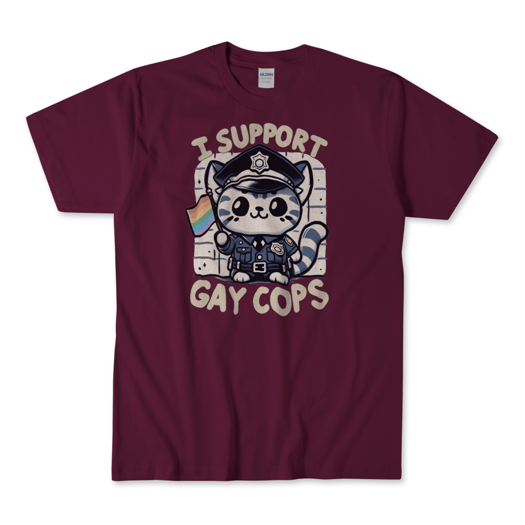 A maroon T-shirt featuring a cute kitten dressed in a police uniform, holding a rainbow flag. The kitten has a friendly and supportive expression. The text "I support gay cops" is displayed in a bold, playful font above and below the kitten. The background is simple and clean, allowing the main elements to stand out prominently. By Left Arrow Tees Company.