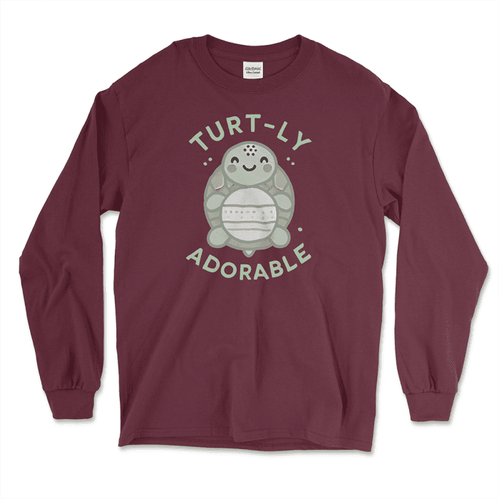 Maroon long-sleeve graphic tee featuring an adorable cartoon turtle design with the phrase 'Turt-ly Adorable' in light green. Perfect for turtle lovers and those looking for unique turtle-themed gifts. Find this and other affordable graphic tees at Left Arrow Tees.
